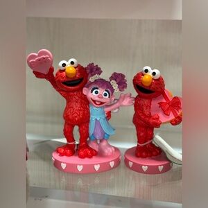 2 Red and Pink Elmo Figurines